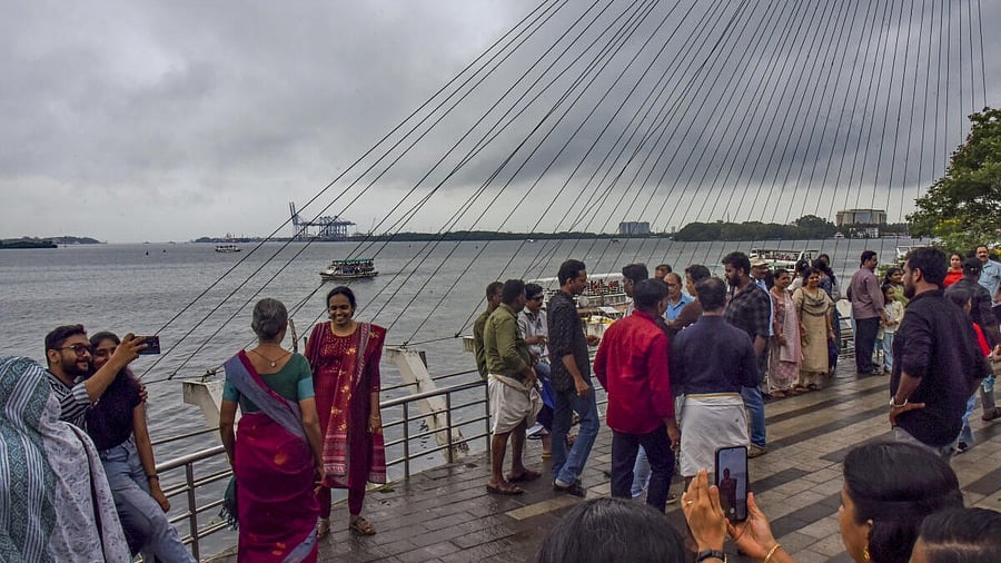 <div class="paragraphs"><p>Visitors at Marine Drive as dark clouds cover the skyline, in Kochi, Kerala</p></div>