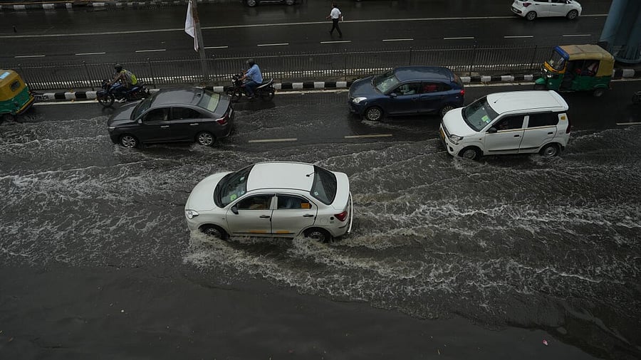 <div class="paragraphs"><p>Vehicles move through a waterlogged road following rains, at ITO in New Delhi, Sunday, May 25, 2025.</p></div>
