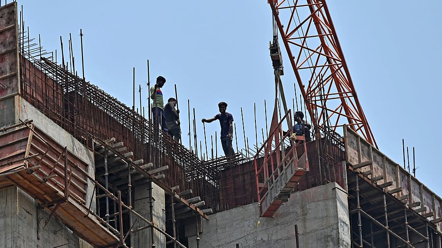 <div class="paragraphs"><p>Workers at a construction site of a high-rise building in Bengaluru.&nbsp;</p></div>