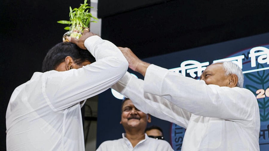 <div class="paragraphs"><p>Bihar Chief Minister Nitish Kumar places a flower pot on the head of Additional Chief Secretary, Education, S. Siddharth during a programme, in Patna, Monday, May 26, 2025. </p></div>