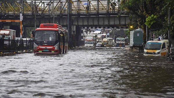 <div class="paragraphs"><p> Vehicles move on a flooded road after heavy monsoon rainfall, in Mumbai.</p></div>