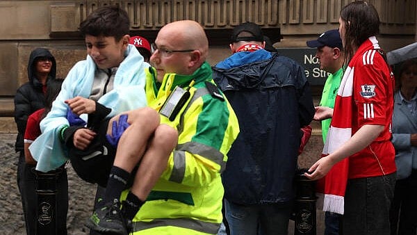 <div class="paragraphs"><p>A paramedic carries a child after multiple people were hit by a car during the Victory parade.</p></div>