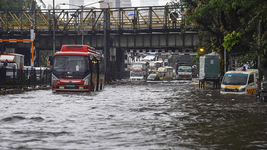 <div class="paragraphs"><p>Vehicles move on a flooded road after heavy monsoon rainfall, in Mumbai, Monday, May 26, 2025. </p></div>