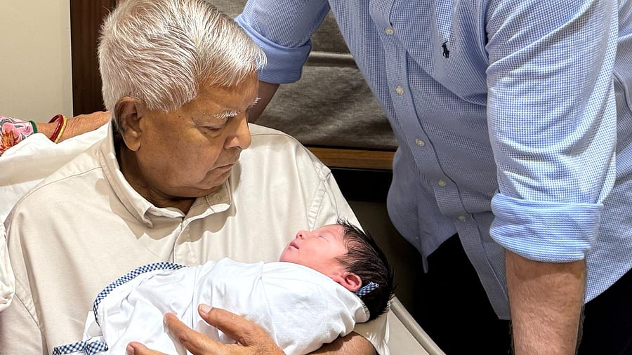 <div class="paragraphs"><p>Lalu holds his grandson</p></div>