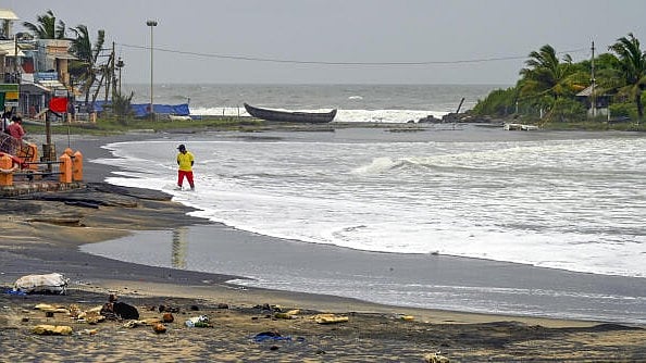 <div class="paragraphs"><p>A man stands as waves crash at the deserted Kovalam Beach, amid fishing restrictions due to bad weather.</p></div>