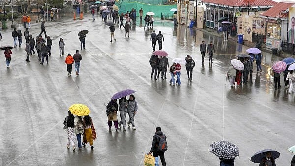 <div class="paragraphs"><p>Commuters on a road amid rain, in Himachal Pradesh.</p></div>
