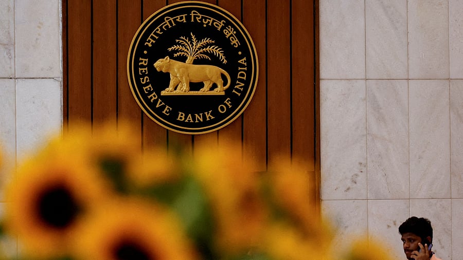 <div class="paragraphs"><p>FILE PHOTO: A man speaks on his phone as he walks past the Reserve Bank of India (RBI) logo inside its headquarters in Mumbai.</p></div>