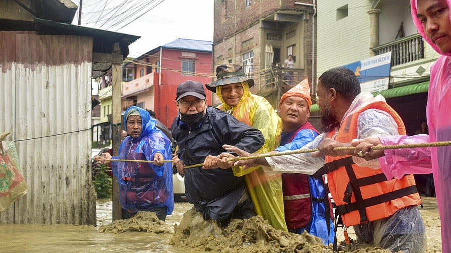 <div class="paragraphs"><p>Rescue personnel assist locals at an area inundated with rainwater after heavy rainfall, in Imphal East district, Manipur, Saturday, May 31, 2025.</p></div>