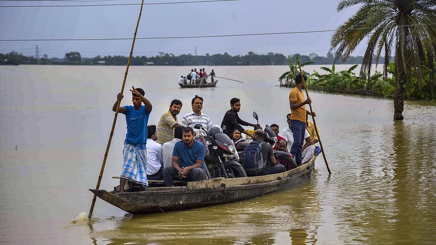 <div class="paragraphs"><p>Villagers are transported on a boat to a safer place from a flood-affected area following heavy rain, at Jamunamukh area, in Hojai district of Assam, Tuesday, June 3, 2025.</p></div>