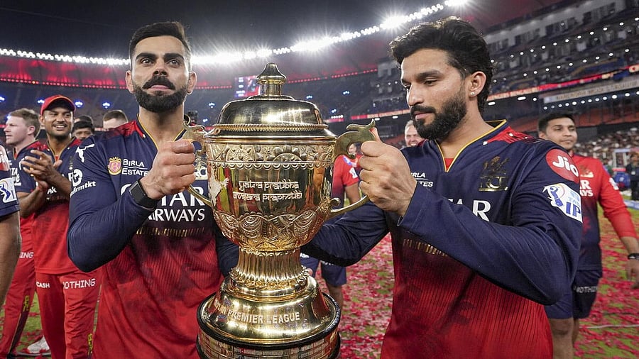 <div class="paragraphs"><p>RCB players with IPL trophy</p></div>