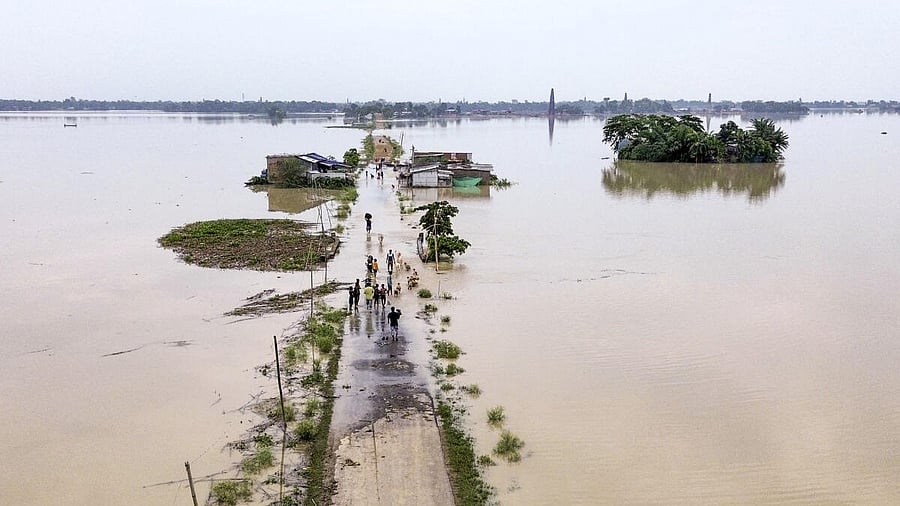 <div class="paragraphs"><p>An aerial view of houses along a road partially submerged in floodwater, in Morigaon district, Assam</p></div>