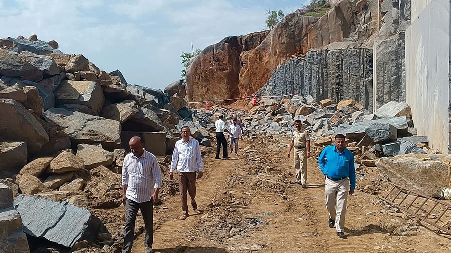 <div class="paragraphs"><p>Police and officials visit the granite quarry at Dhumagere village, Hassan taluk, on Friday. </p></div>