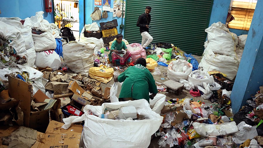 <div class="paragraphs"><p>A waste worker segregates dry waste at a segregation unit in Jayanagar, Bengaluru on Friday. </p></div>