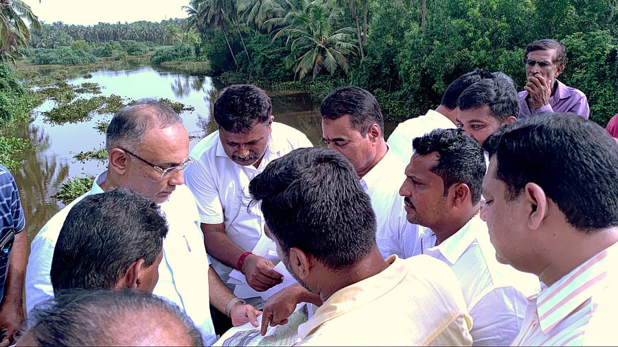 The members of the Nandini Nadi Samrakshana Samithi, Mangaluru, residents
of Chelairu and local elected members speak to District In-charge Minister
Dinesh Gundu Rao during his visit to Chelairu on Wednesday. DH Photo