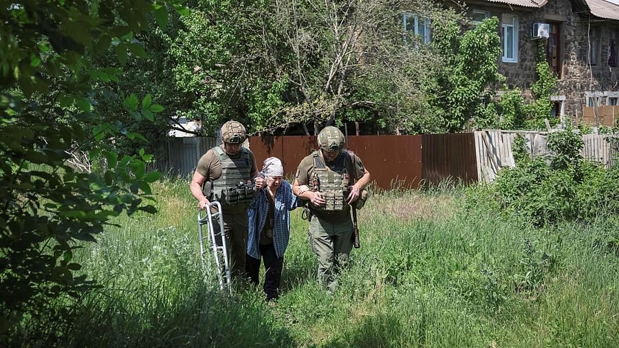 <div class="paragraphs"><p>Police officers accompany an elderly woman during evacuation, amid Russia's attack on Ukraine, in the frontline town of Kostyantynivka, Donetsk region, Ukraine.</p></div>