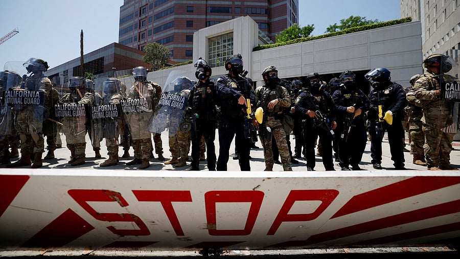 <div class="paragraphs"><p>Members of the California National Guard stand guard, as a demonstration against federal immigration sweeps takes place, outside the Edward R. Roybal federal building, after their deployment by US President Donald Trump, in response to protests, in Los Angeles, California, June 8, 2025.</p></div>