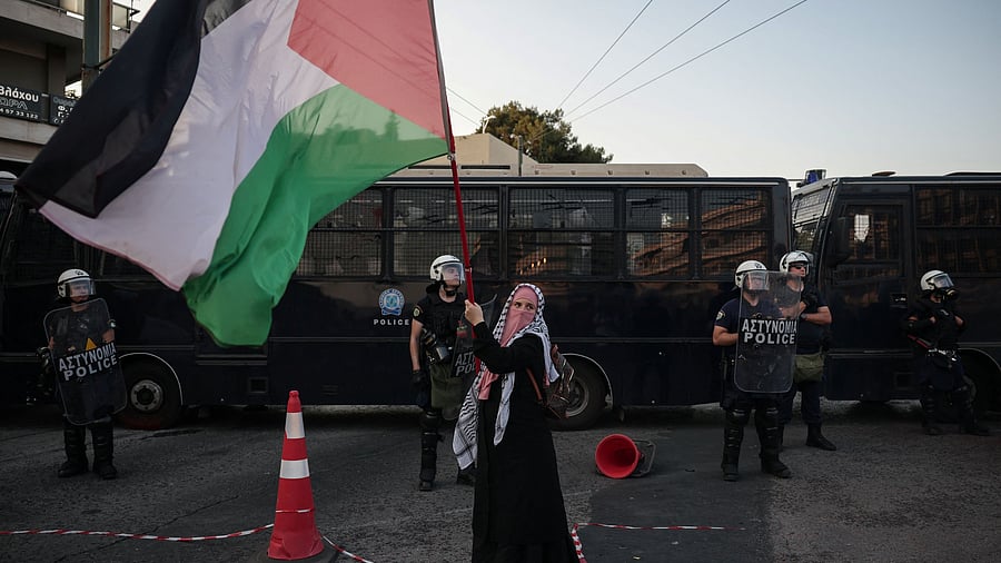 <div class="paragraphs"><p>A woman waves a Palestinian flag during a protest in front of the Israeli embassy in Athens, following the seizure by Israeli forces of the Gaza-bound charity vessel Madleen, operated by pro-Palestinian Freedom Flotilla Coalition, in Athens, Greece, June 9, 2025. </p></div>