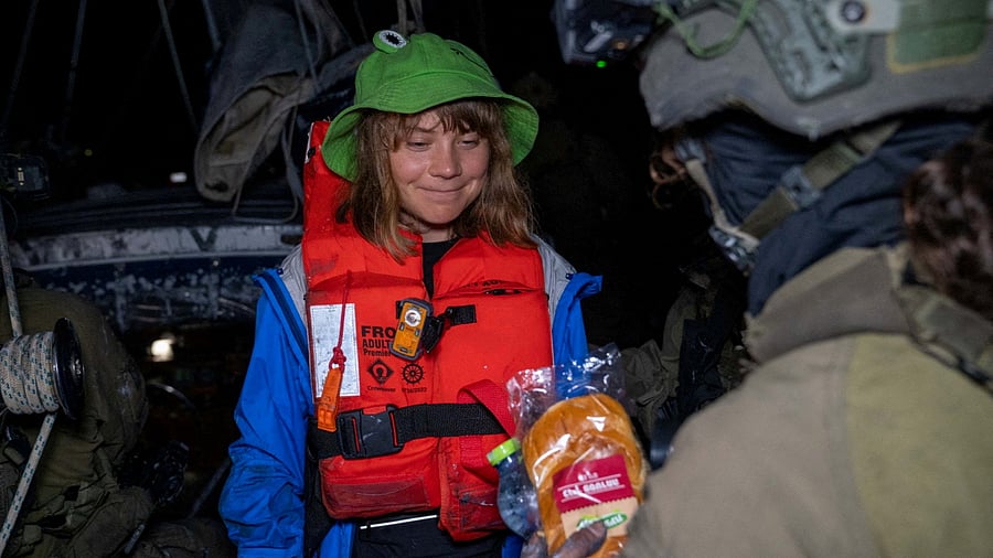 <div class="paragraphs"><p>An Israeli solider passes a bun to Greta Thunberg onboard the Gaza-bound British-flagged yacht "Madleen" after Israeli forces boarded the charity vessel as it attempted to reach the Gaza Strip in defiance of an Israeli naval blockade, in this still image released on June 9, 2025.</p></div>