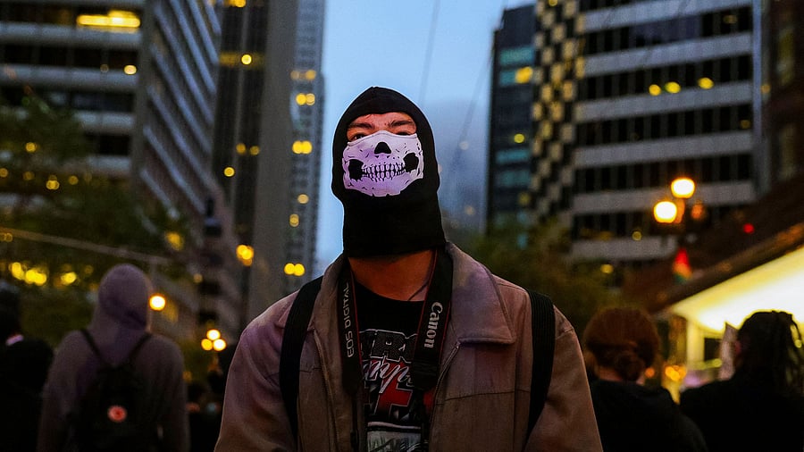 <div class="paragraphs"><p>A demonstrator looks at the police officers (not pictured) during a protest against federal immigration sweeps on Market Street in San Francisco, California, US, June 8, 2025.</p></div>