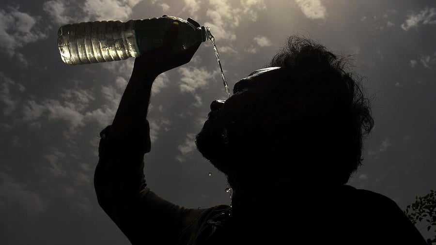 <div class="paragraphs"><p>A man splashes water on his face on a hot summer day amid heatwave</p></div>