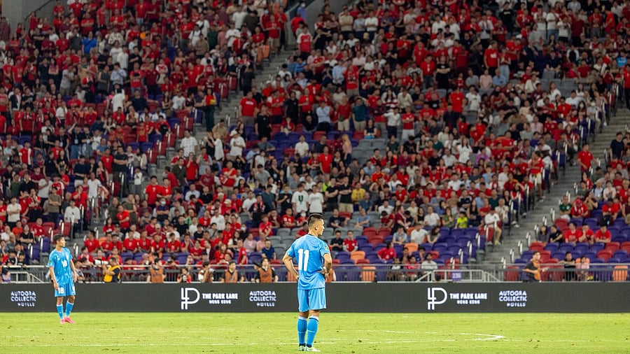 <div class="paragraphs"><p>Sunil Chhetri stands dejected after India's loss to Hong Kong</p></div>
