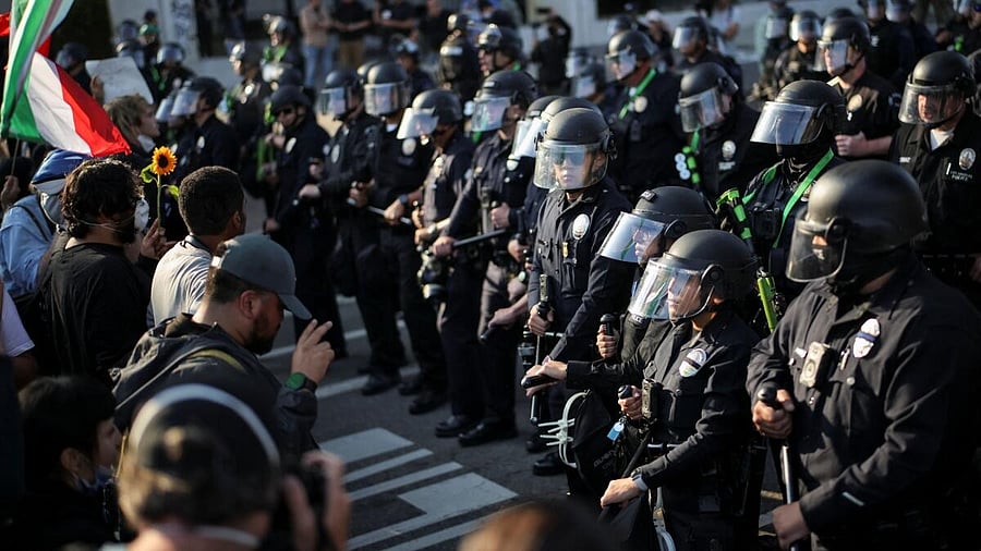 <div class="paragraphs"><p>Members of law enforcement stand guard as protests against federal immigration sweeps continue, in Los Angeles, California</p></div>