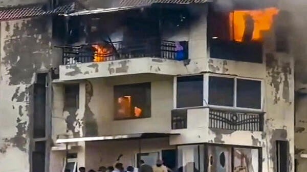 <div class="paragraphs"><p>People wait to be rescued after a fire broke out in a residential building, at Dwarka, in New Delhi.</p></div>