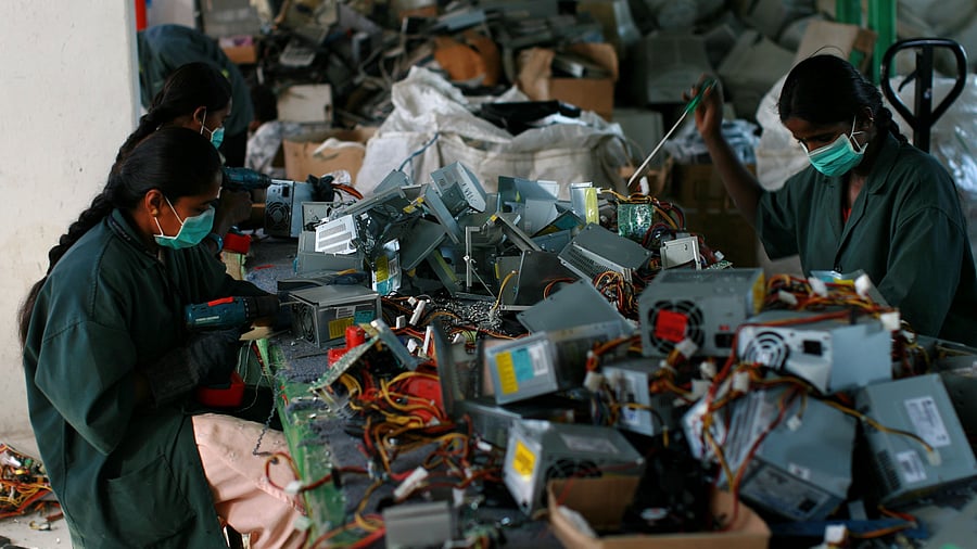 <div class="paragraphs"><p>Workers at an electronic waste recycling factory. </p></div>