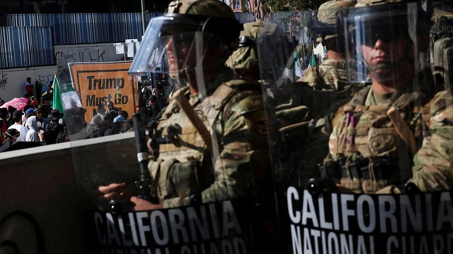 <div class="paragraphs"><p>Members of the California National Guard stand in a line, blocking an entrance to the Federal Building, as demonstrators gather nearby, during protests against immigration sweeps, in Los Angeles</p></div>