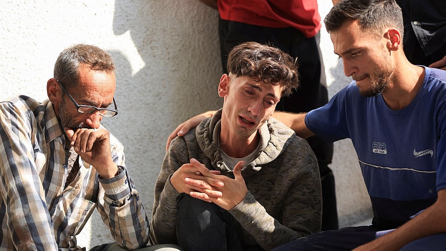 <div class="paragraphs"><p>Palestinians react over the bodies of their relatives killed by Israeli fire, according to the Gaza health ministry, near an aid distribution center in central Gaza, at Al-Shifa hospital, in Gaza City, June 11, 2025. </p></div>