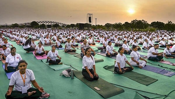 <div class="paragraphs"><p>People perform yoga during a day-long yoga camp ahead of International Yoga Day</p></div>