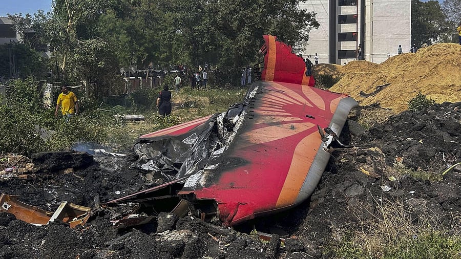 <div class="paragraphs"><p>People stand near the debris of the Air India plane that crashed moments after taking off from Ahmedabad&nbsp;airport.&nbsp;</p></div>
