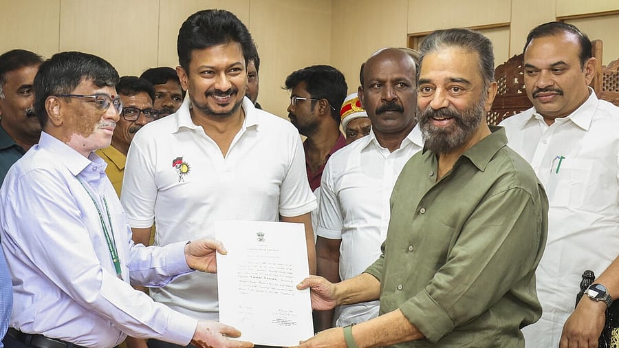 <div class="paragraphs"><p>Tamil Nadu Deputy CM Udhayanidhi Stalin looks on as Kamal Haasan receives the certificate after being declared elected unopposed to the Rajya Sabha. </p></div>