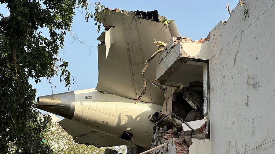 <div class="paragraphs"><p>A tail of an Air India Boeing 787 Dreamliner plane that crashed is seen stuck on a building after the incident in Ahmedabad, India, June 12, 2025.</p></div>