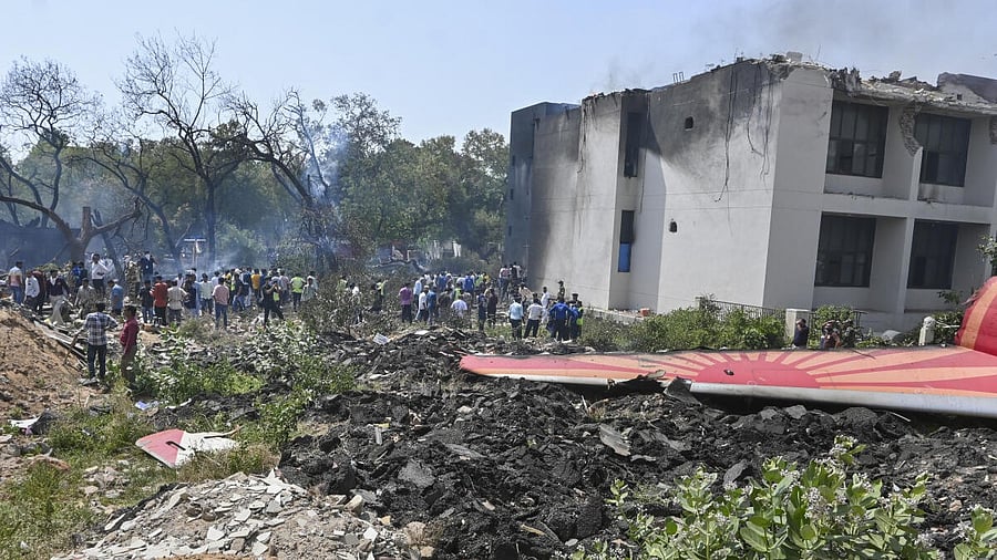<div class="paragraphs"><p>People near the debris of the Air India plane that crashed moments after taking off from Ahmedabad airport.&nbsp;<br></p></div>