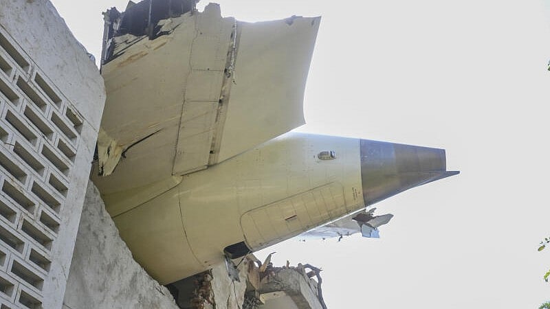 <div class="paragraphs"><p>A damaged part of the Air India plane that crashed moments after taking off from the airport, lies on a residential building in Ahmedabad, Thursday, June 12, 2025.</p></div>