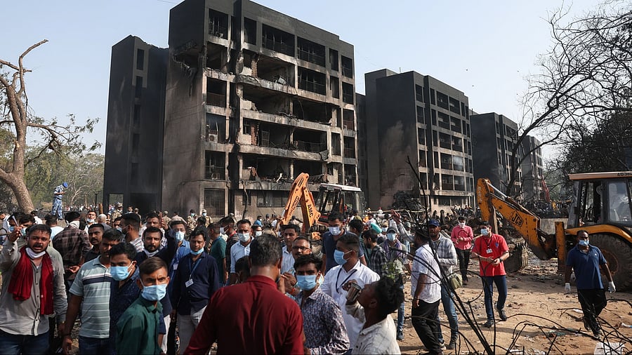 <div class="paragraphs"><p>People gather near a damaged building at the site where an Air India Boeing 787 Dreamliner plane crashed in Ahmedabad, India.</p></div>