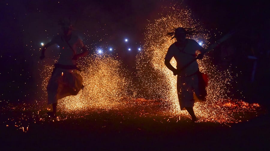 <div class="paragraphs"><p>Rabha tribal priests perform a traditional fire test dance during the Baikho festival in Kamrup district of Assam om Wednesday. The festival is celebrated annually to bring usher in the harvest season.</p></div>