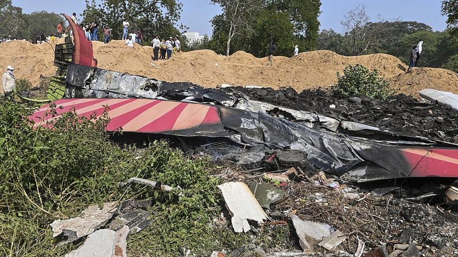 <div class="paragraphs"><p>People near the debris of the Air India plane that crashed moments after taking off from the airport, in Ahmedabad, Thursday, June 12, 2025. The London-bound plane was carrying 242 passengers.</p></div>