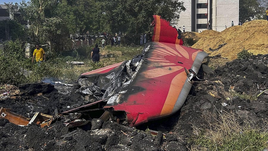 <div class="paragraphs"><p>People near the debris of the Air India plane that crashed moments after taking off from the airport, in Ahmedabad, Thursday, June 12, 2025. The London-bound plane was carrying 242 passengers.</p></div>