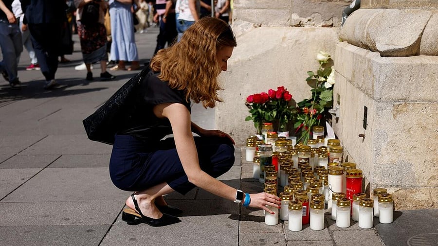 <div class="paragraphs"><p>A person lights a candle in front of St. Stephen's Cathedral in honour of the victims of a deadly shooting at a secondary school in Graz, at Stephansplatz in Vienna, Austria, June 11, 2025.</p></div>