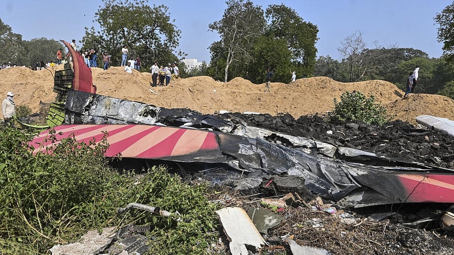 <div class="paragraphs"><p>People near the debris of the Air India plane that crashed moments after taking off from the airport, in Ahmedabad.</p></div>