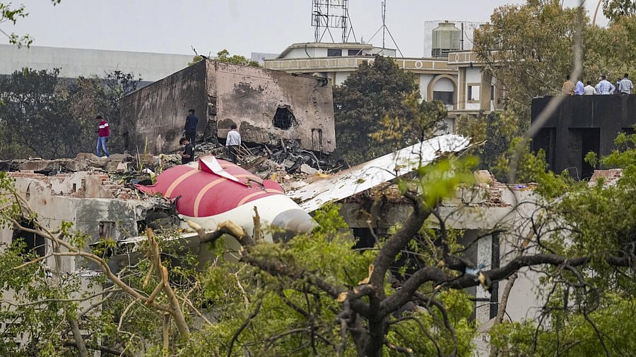 <div class="paragraphs"><p>Remains of the crashed Air India plane lie on a building, in Ahmedabad.</p></div>