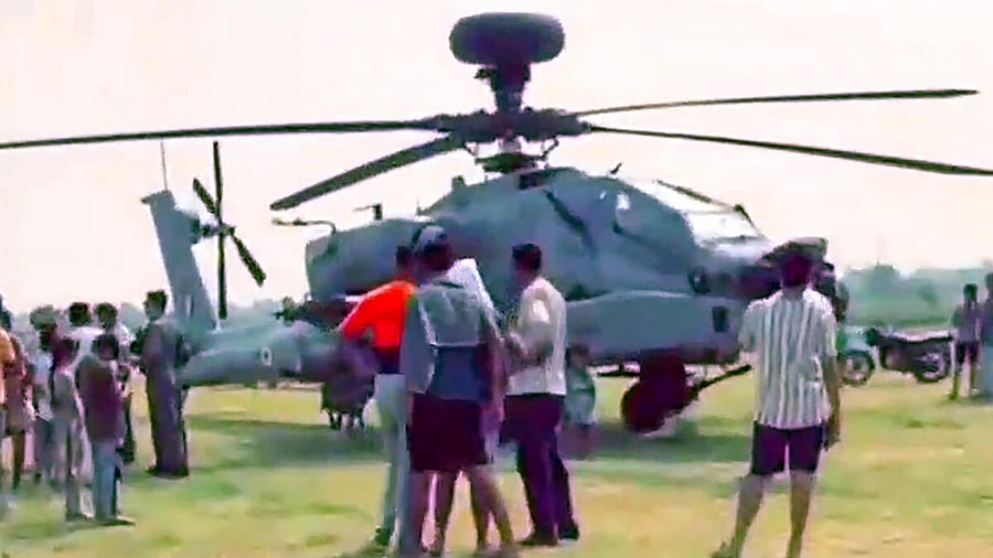 <div class="paragraphs"><p>People gather near IAF Apache helicopter which made a precautionary landing. </p></div>