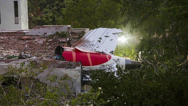 <div class="paragraphs"><p>Remains of the Air India plane that crashed moments after taking off from the Ahmedabad airport, lies on a building in Ahmedabad.</p></div>
