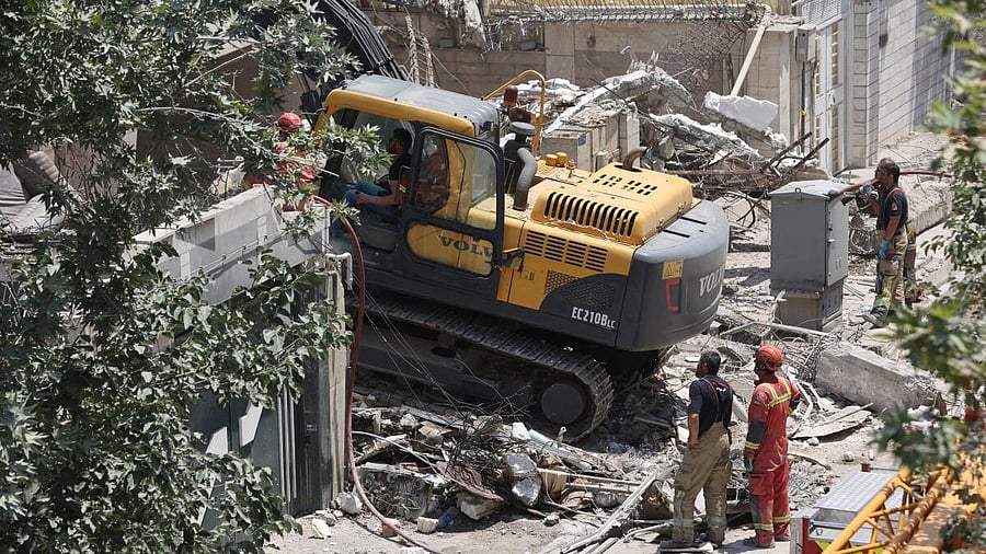 <div class="paragraphs"><p>Rescuers work at the site of a damaged building, in the aftermath of Israeli strikes, in Tehran, Iran, June 14, 2025.</p></div>