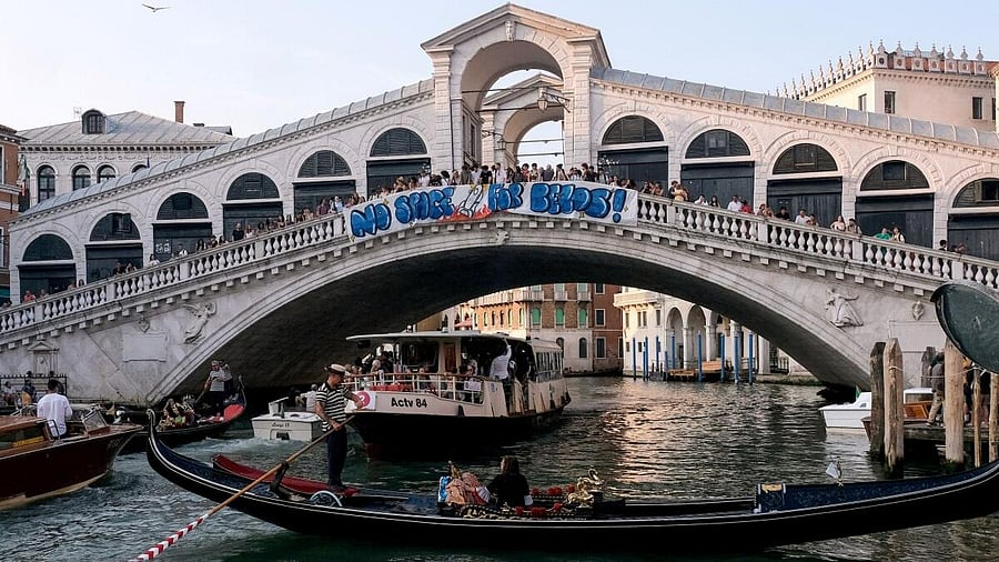 <div class="paragraphs"><p>Protesters display a banner reading "No Space for Bezos!" on the Rialto Bridge during a protest against Amazon founder Jeff Bezos' upcoming wedding to Lauren Sanchez being held in Venice, Italy, June 13, 2025. </p></div>