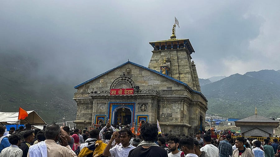 <div class="paragraphs"><p>Visitors at Kedarnath temple.</p></div>
