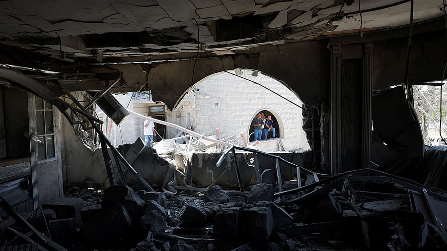 <div class="paragraphs"><p>People look at the damage after missiles fired from Iran impacted a residential building, in Tamra, northern Israel June 15, 2025. </p></div>