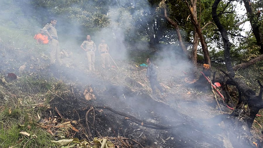 <div class="paragraphs"><p>Security personnel at the spot after a helicopter crashed near the Kedarnath shrine.</p></div>